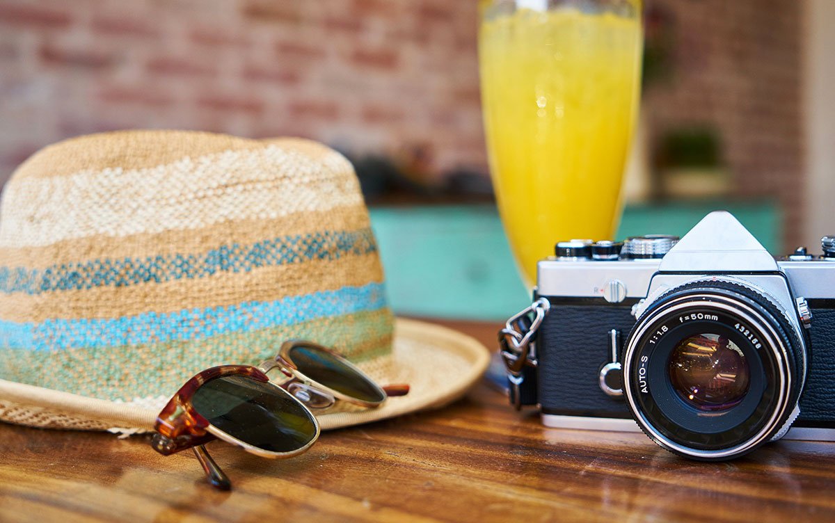 Vegan Voyages: The world of delicious, ethical eating sunhat and sunglasses with camera and juice